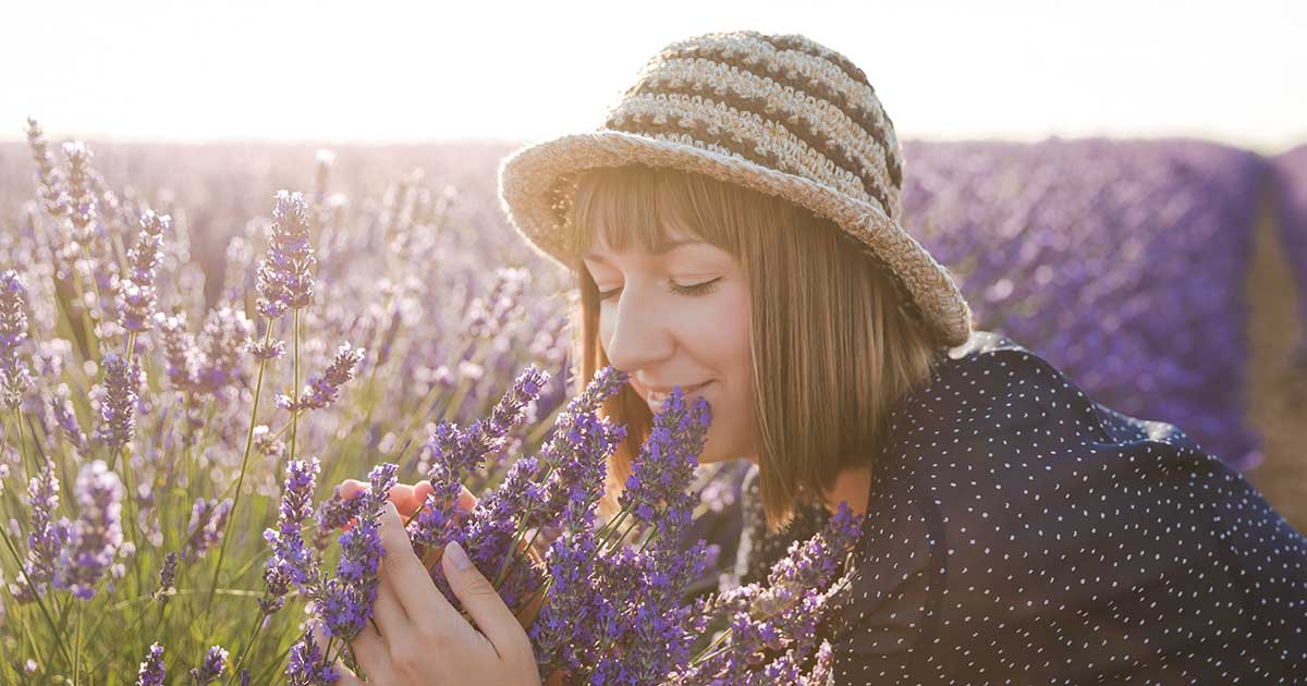 A woman smelling lavender