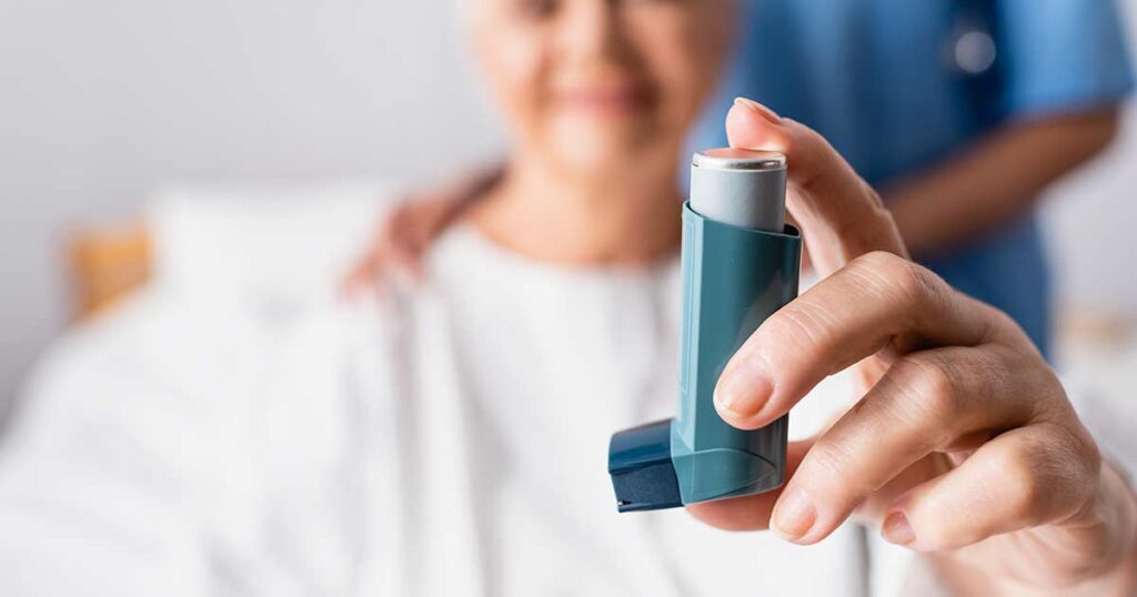A woman in the hospital with an inhaler