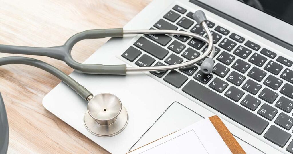 stethoscope on a laptop while doing nursing online education