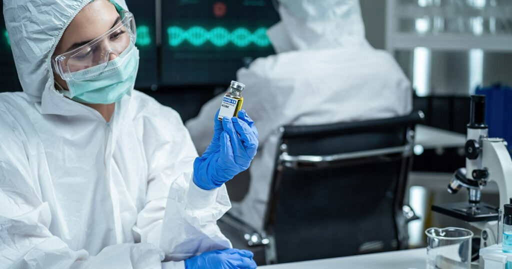 Image of nurse reading the Covid-19 vaccine vile